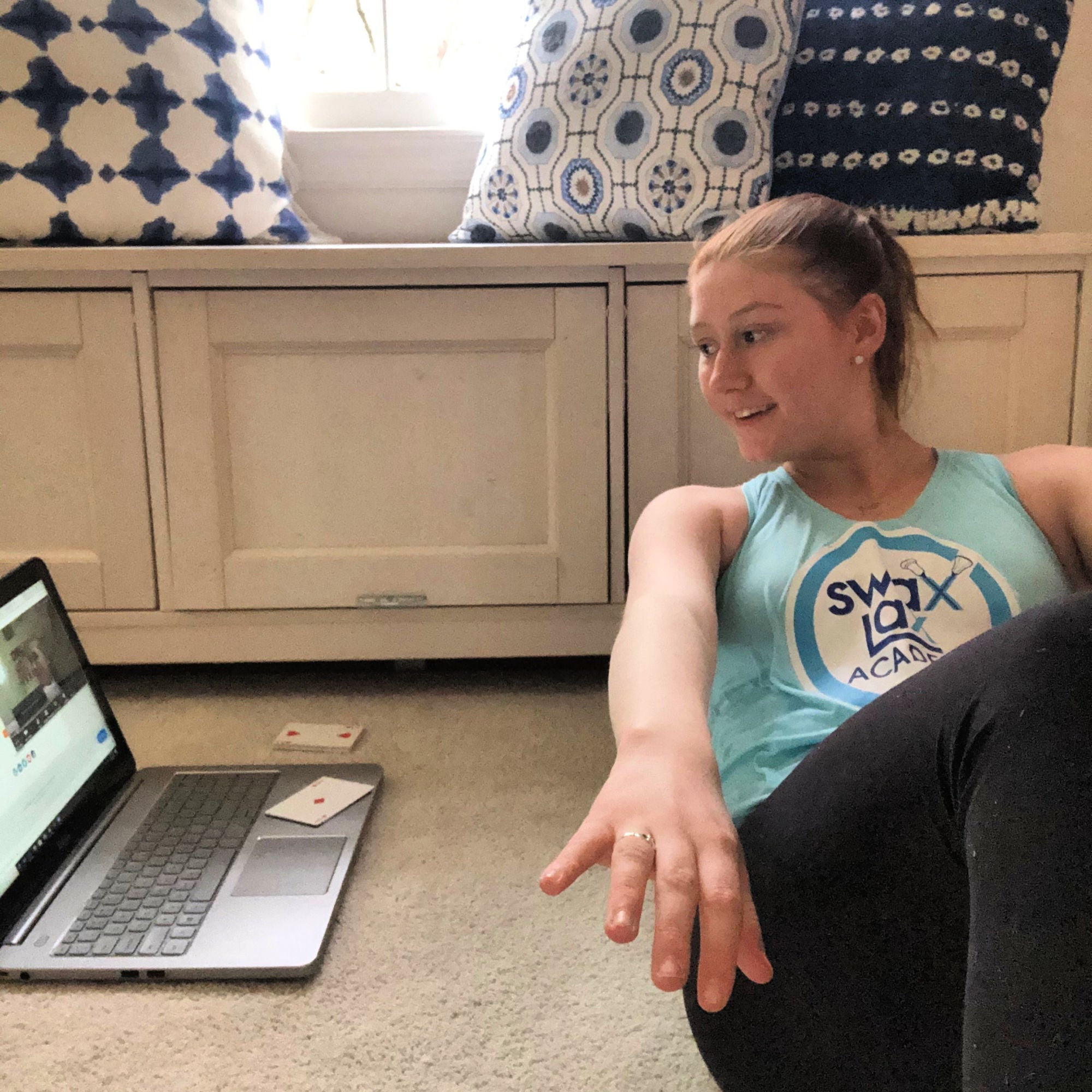 Liza doing lacrosse training using a deck of cards as a training aid