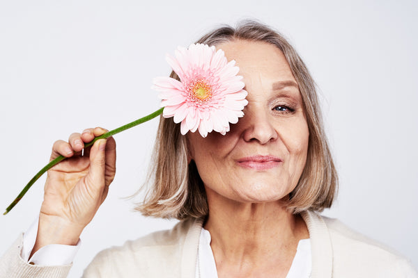 mature woman holding flower