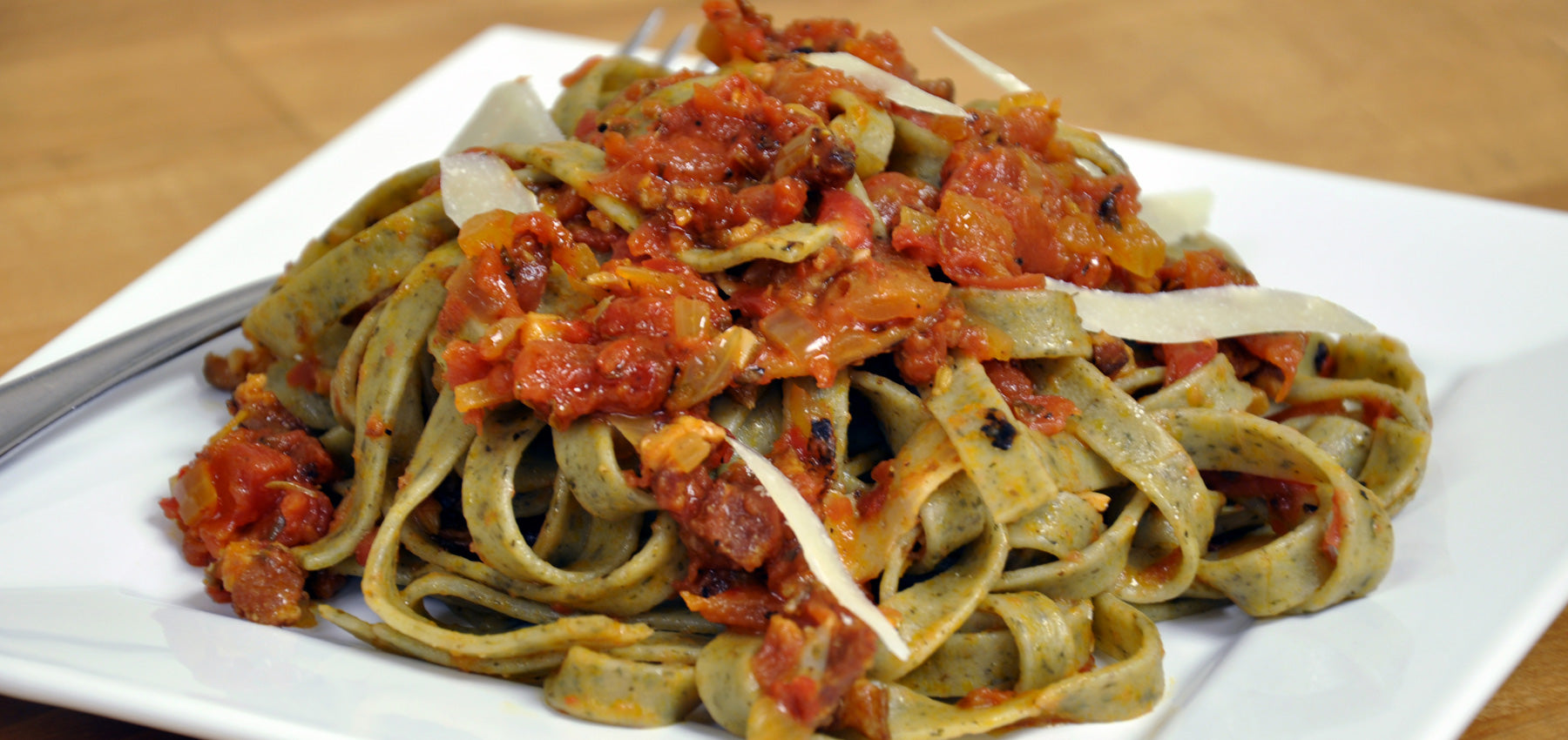 Roasted Garlic Herb Fettuccine tossed with Spiced Muir Glen Fire Roasted Tomatoes & Applewood Smoked Bacon Sauce