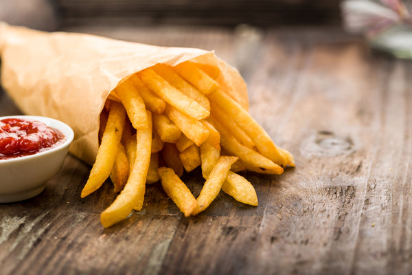 Chips (french fries) lying on a wooden board