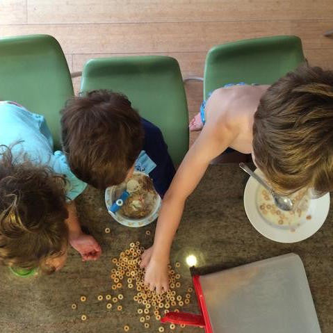 Three children at the breakfast table