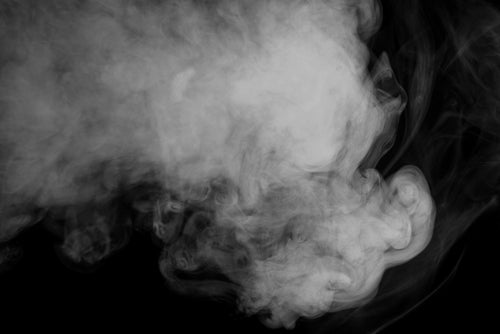 Black and white image of steam on a black background