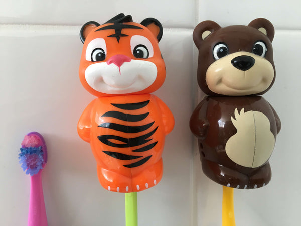 Image of two children's toothbrush holders and a single toothbrush with no holder