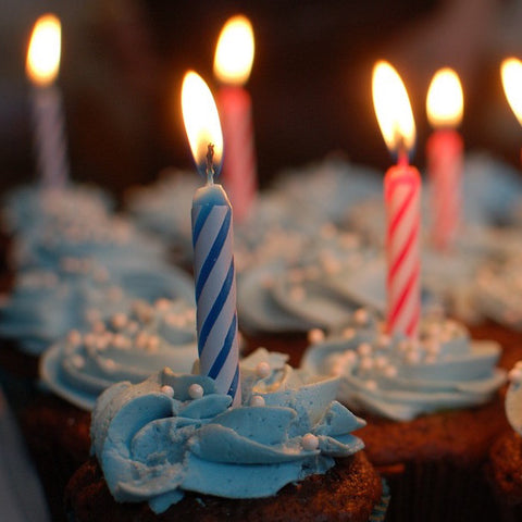 Cupcakes with birthday candles, one in each