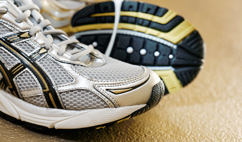 A close-up shot of a pair of conventional athletic shoes with thick soles and toe spring