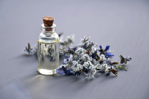Bottle with clear liquid and flowers
