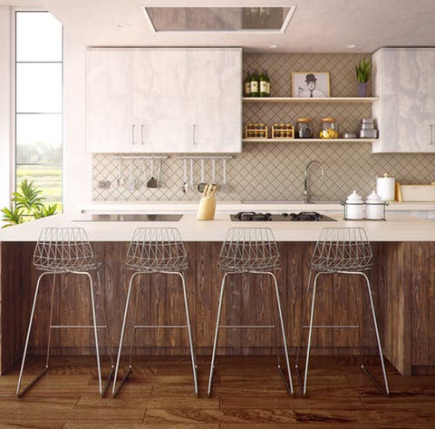 Clean white and brown kitchen with metal kitchen stools.