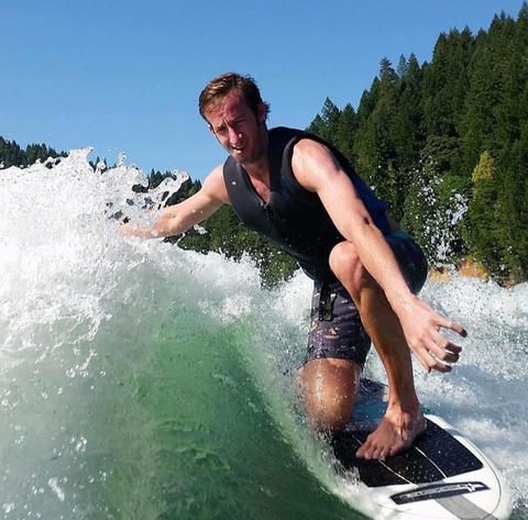 male rider wakesurfing on a doomswell nubstep at the lake