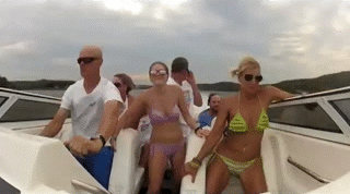 group of people falling while riding fast boat