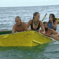 men and women with paddle flipping out of yellow boat