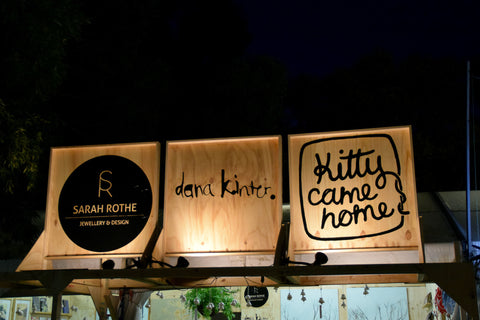 Night-time WOMAD signs for Kitty Came Home, Sarah Rothe Jewellery and Dana Kinter Art