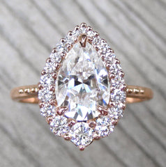 Engagement Ring with a Pear Moissanite Center with Diamond Halo in Rose Gold