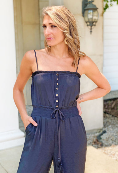 Day To Night Jumpsuit, Black jumpsuit featuring a relaxed fit, with a comfortable elastic waist, a sleeveless design, and front button details