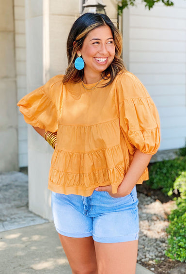 Total Upgrade Blouse in Orange, Lightweight orange blouse with tiered detailing, Features puff sleeves and a slightly cropped hem.