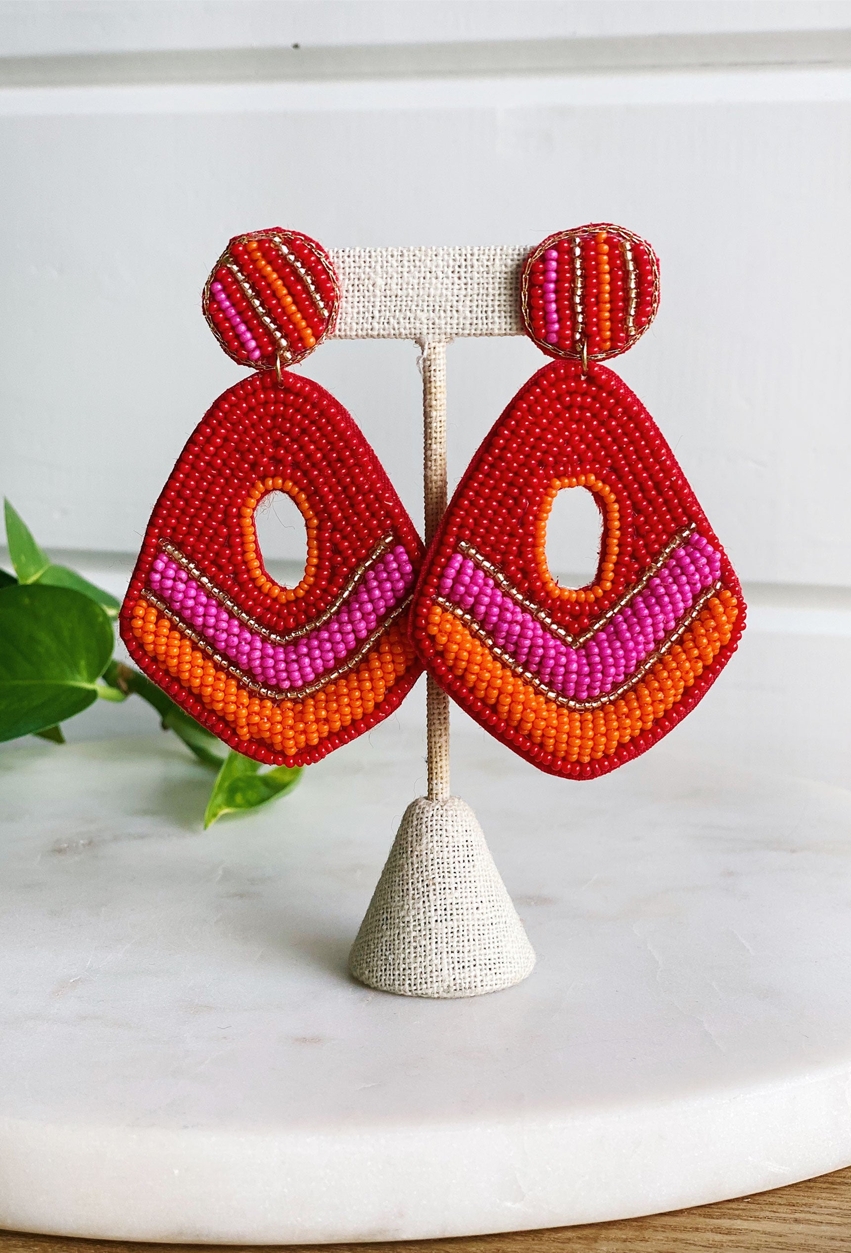 Bondi Beach Beaded Earrings, Teardrop shaped earring with a hole in the middle, pink, red, orange and gold beads, felt backing, post back