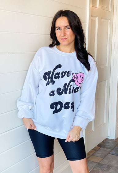 Have A Nice Day Graphic Pullover, white graphic pullover with "have a nice day" on front with a pink smiley face making the peace sign