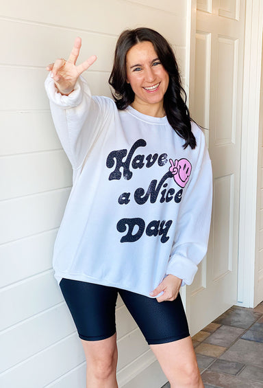 Have A Nice Day Graphic Pullover, white graphic pullover with "have a nice day" on front with a pink smiley face making the peace sign