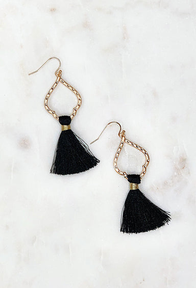 Isabella Fringe Earrings in Black, gold spade shaped earrings with black tassel hanging off on a hook backing