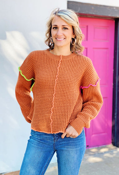 Seattle Bound Knit Sweater, orange knit sweater with exposed neon green and yellow stitching
