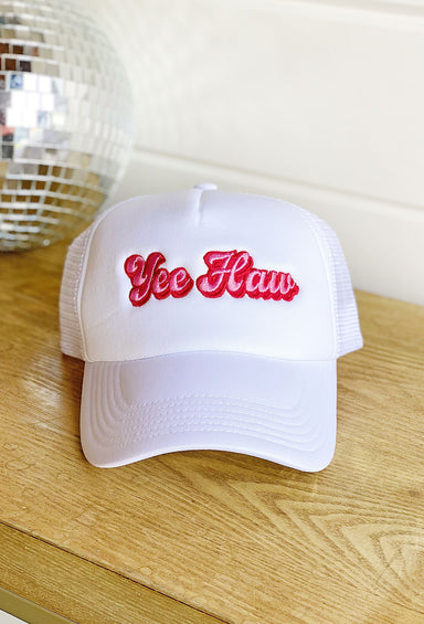 Yee Haw Trucker Hat, white trucker hat with pink and red embroidered "tee haw" on the front of the hat, white meshing, adjustable 