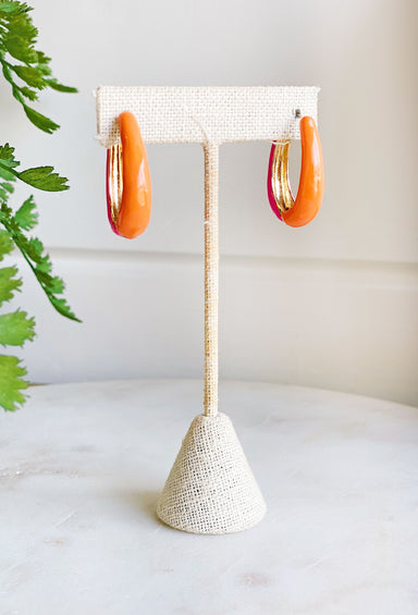 On Sunshine Time Earrings, half pink and half orange hoop earrings