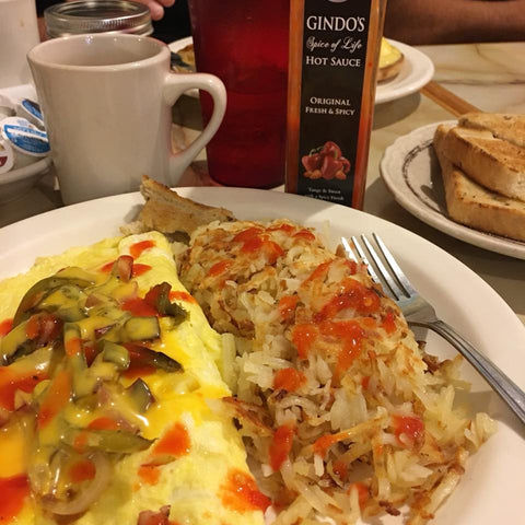 Denver omelette with hash browns and Gindo's Original Fresh & Spicy, a 7x award-winning Louisiana style hot sauce.