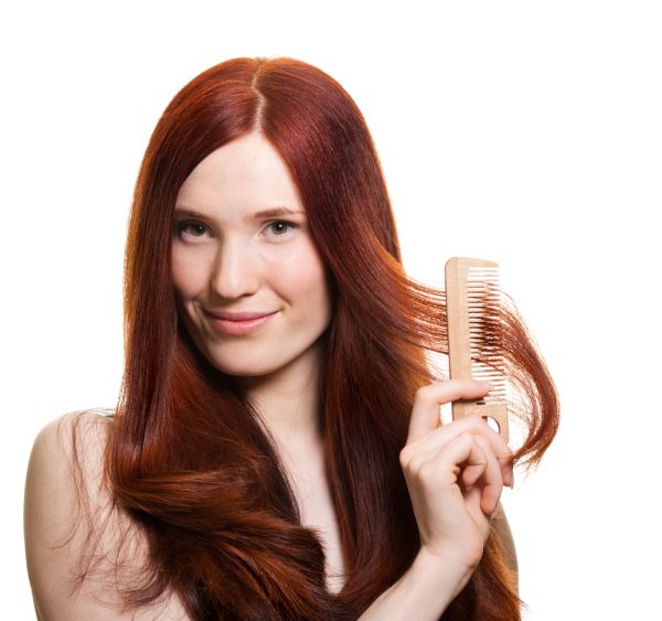 Red Haired Woman Combing Hair Away From Face ISA Professional