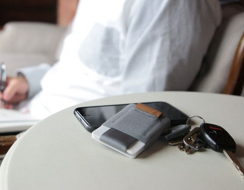 gray nomatic wallet on a desk
