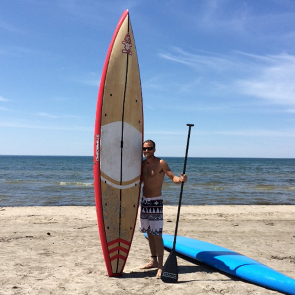 Stand up paddle boarder Brandon Lourie at the beach