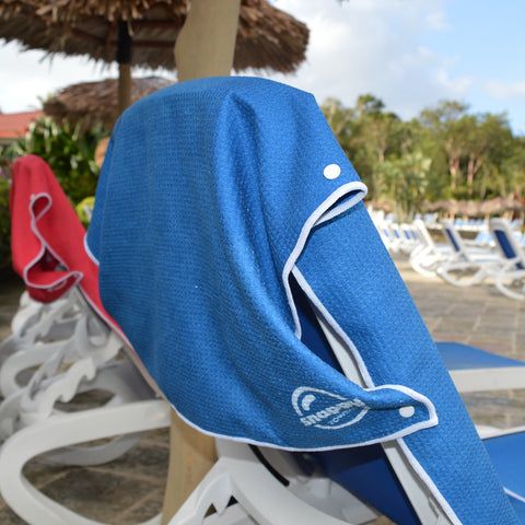 Snappy Towels microfiber beach towels attach over the back of your chair so that they won't blow away or fall down.