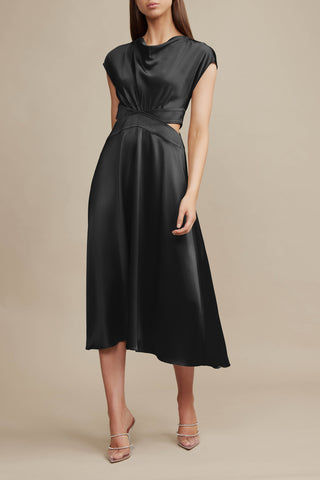 A model stands against a beige background wearing Acler's Plympton Dress in Black