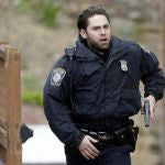 Uniformed men with gun in hand