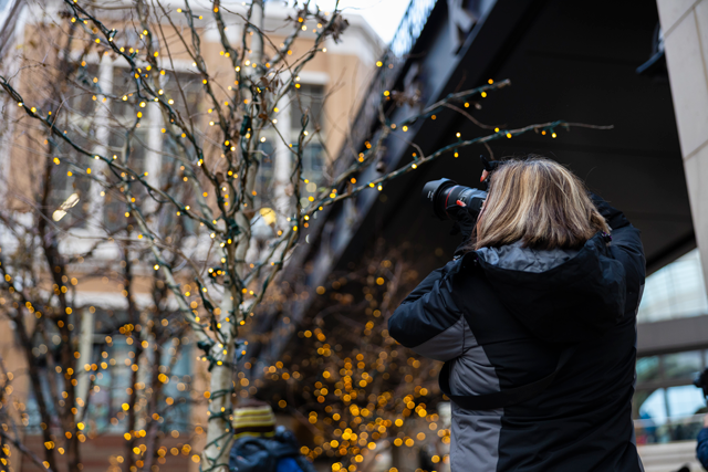 Photographer capturing the lights in the trees outside city creek 