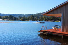 Bass boat going by boathouse