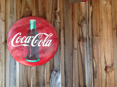 Coca Cola sign on wood