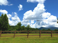 Clouds rising above fence