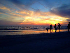 Shadow of family on sunset beach