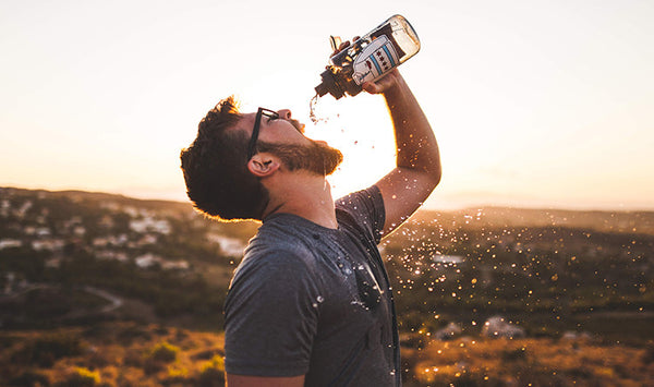 man with beard drinking water