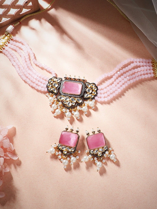 Rubans gold plated kundan choker set with white coloured beads and pastel pink stones.