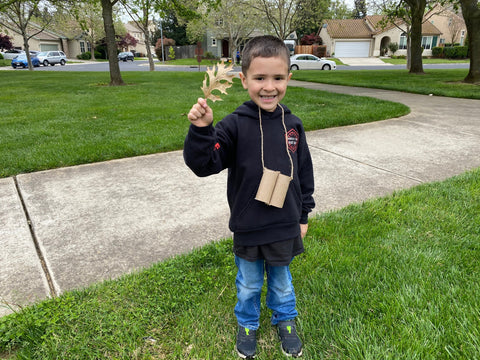 Mike's son holding a pinecone