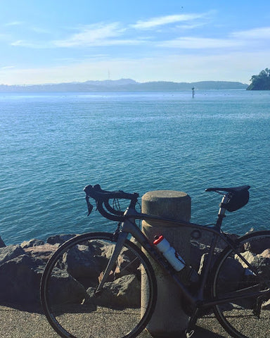 Bike leaning on a post in Marin overlooking the water.