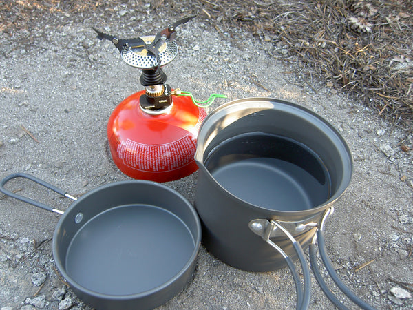 Two pots with water and a small Jet Boil stove