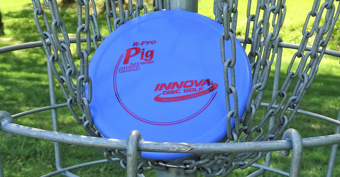 Innova R-Pro Pig resting in the chains of a disc golf basket at sabattus disc golf