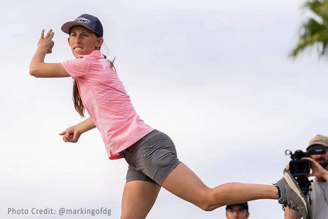 paige pierce following through on a backhand disc golf drive