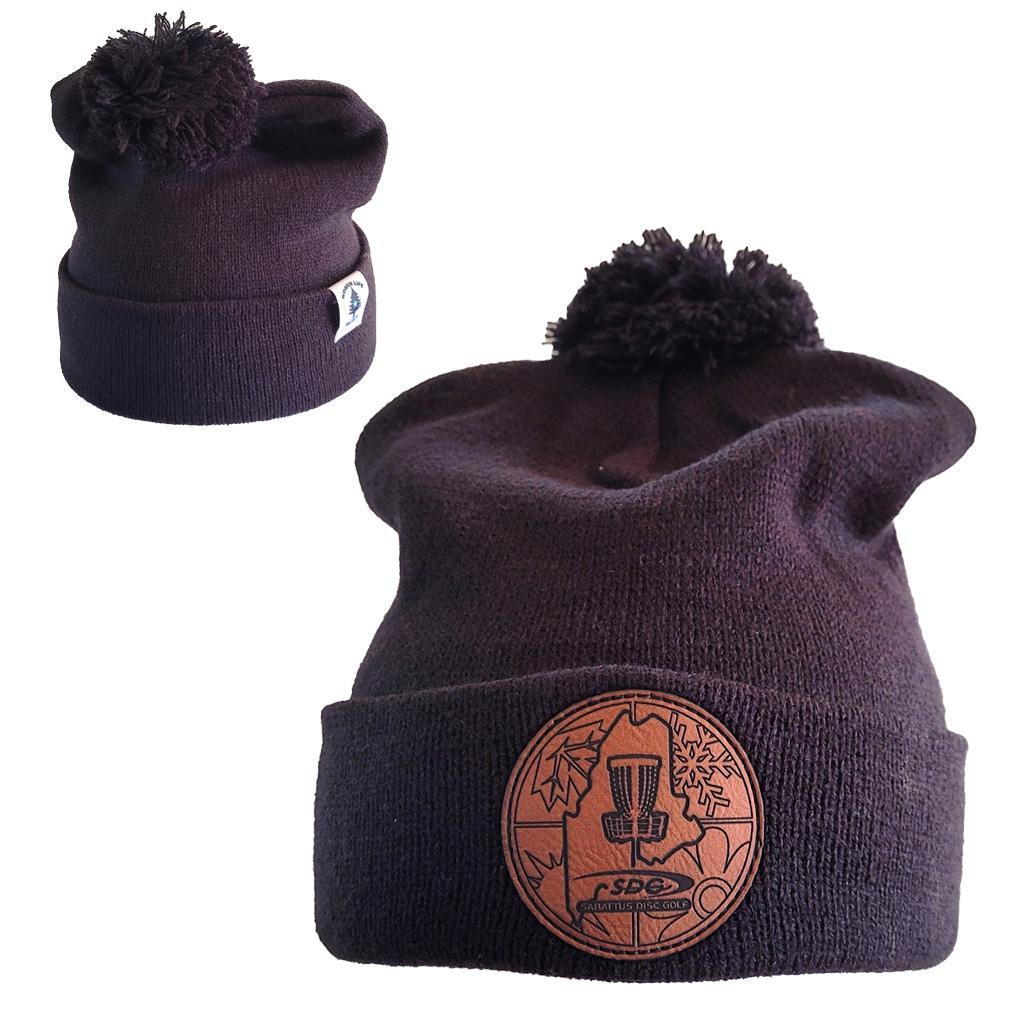 Black colored Knit Pom Pom Beaning with SDG trainzwholesale Laser Engraved on leather patch that is sewn to the front of the hat, also a back view of the hat with the Rogue Life Maine logo on a small white tag sewn to the hat rim 