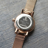 Rose gold mesh watch with case back engraving