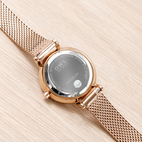 Stone set into the back of the watch on a rose gold mesh