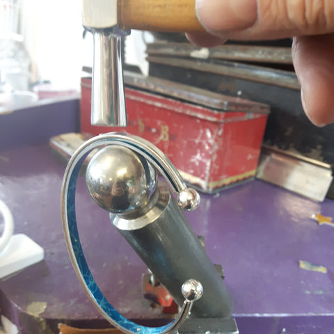 Hammering the rivets on the July Larkspur bangle