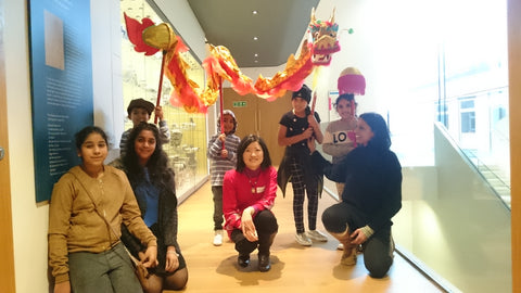 Su Yen pictures with a group of children and Dancing Dragon in the Ashmolean Musuem at Land of Dragon event