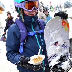 Snowboarder eating breakfast